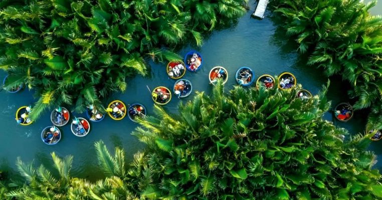 Basket boats take tourists through narrow paths on the river