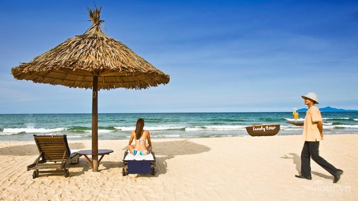 Tourists relax and sunbathe on Bac My An beach