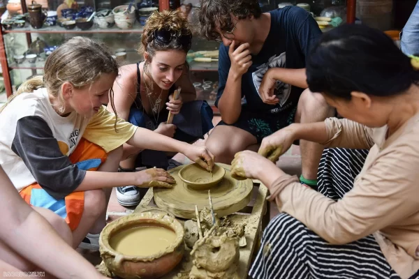 Tourists try making pottery at Bat Trang Village