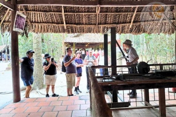 Visitors hear war stories at Cu Chi.