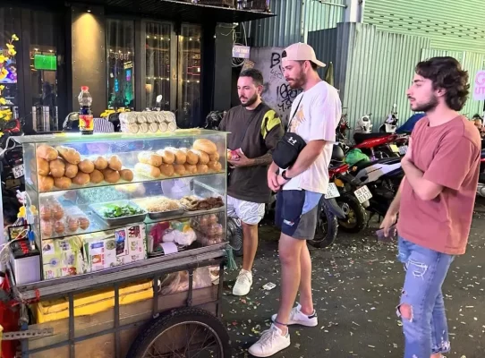 Tourists explore Ho Chi Minh street food.