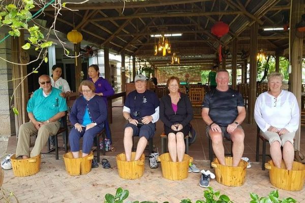 Tourists relax with herbal foot bath.