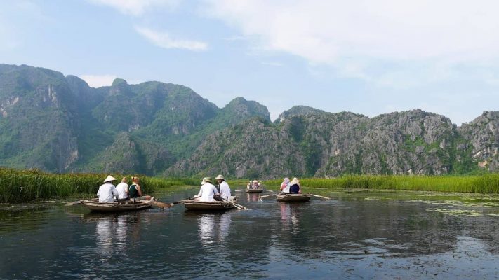 Tourists take a slow boat ride to admire Van Long Nature Reserve.