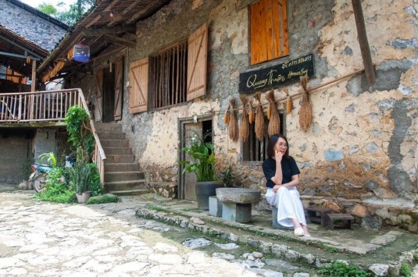 Tourists take photos with the unique architecture in the stone village.